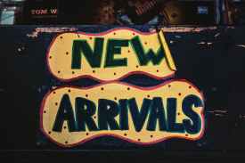 new arrivals sign on wooden surface